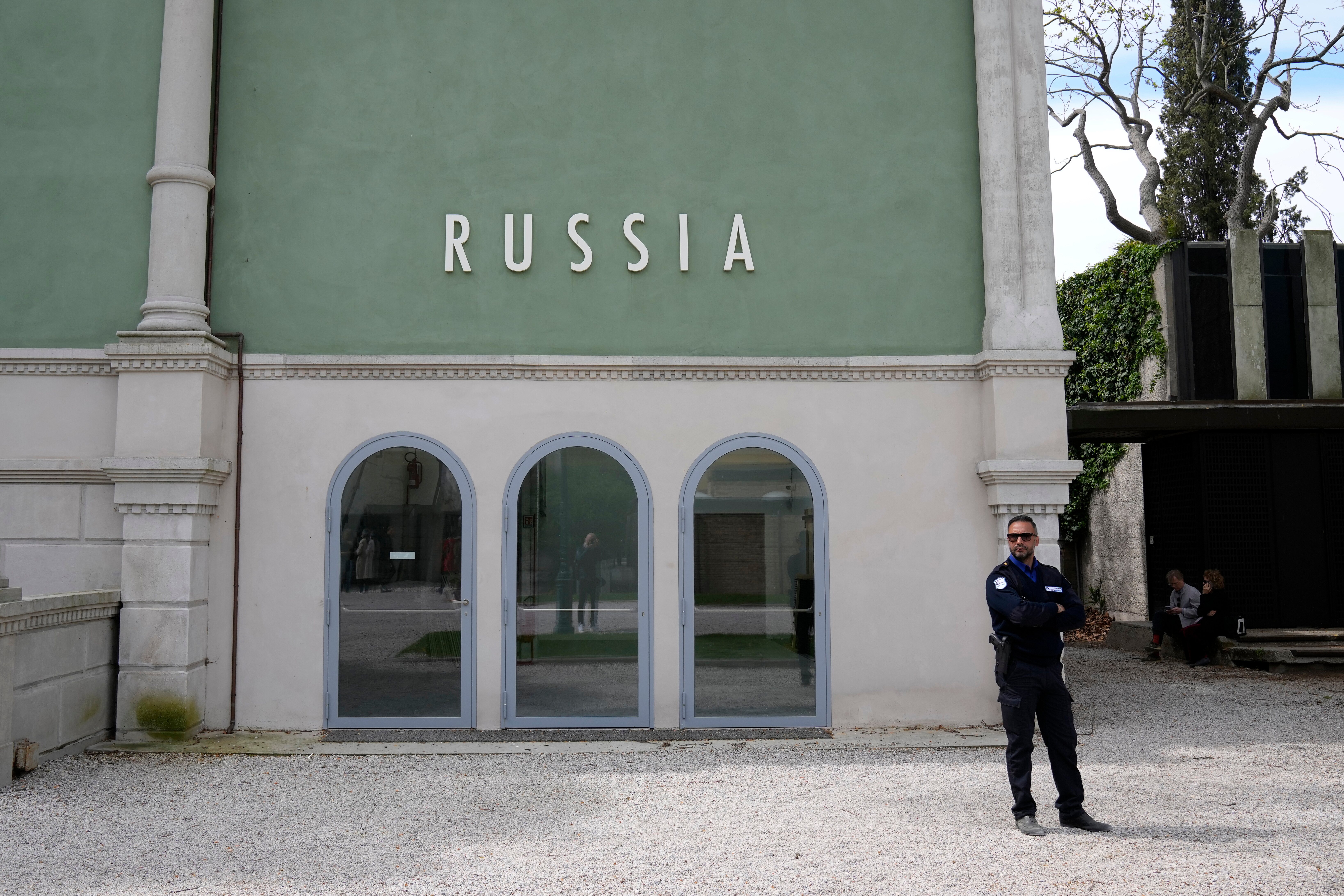 FILE - A private security officer stands next to a closed Russia